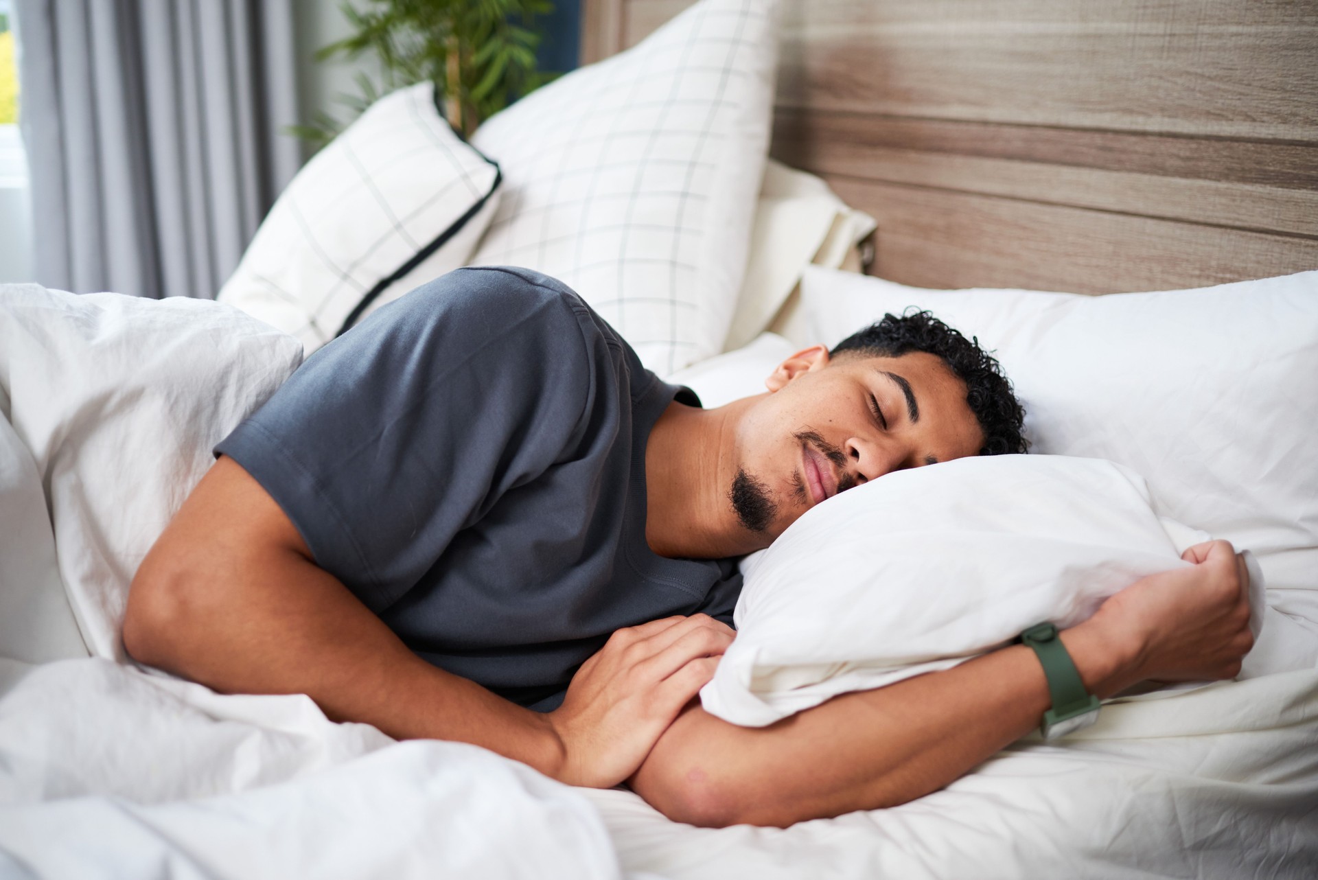 Young Man Peacefully Sleeping in a Comfortable Bed on a Quiet Morning